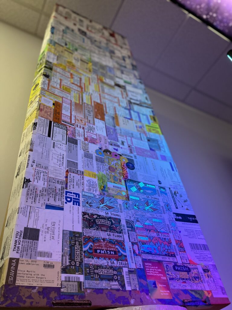 Close-up of Valerie’s cremation container covered in ticket stubs.